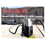 A KleenRite V-Boost Vac Booster, which is a portable vacuum booster unit, with a gray and black color scheme, featuring a handle, wheels, and a power cord.